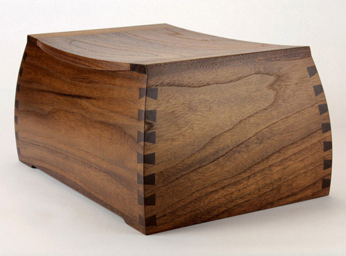 A shapely wood cremation urn